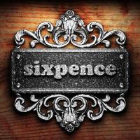 sixpence word of iron on wooden background photo