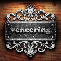 veneering word of iron on wooden background photo