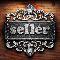seller word of iron on wooden background photo