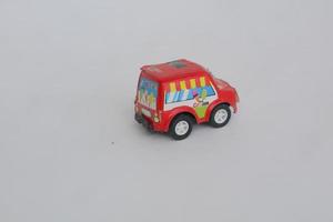 small red toy car on a white background photo