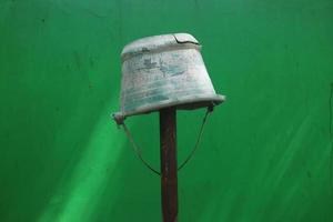 broken bucket placed on iron pipe photo