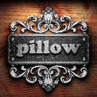 pillow word of iron on wooden background photo