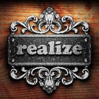 realize word of iron on wooden background photo