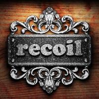 recoil word of iron on wooden background photo