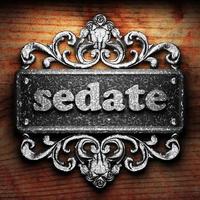 sedate word of iron on wooden background photo