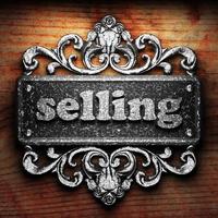 selling word of iron on wooden background photo