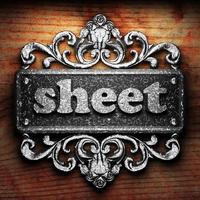 sheet word of iron on wooden background photo