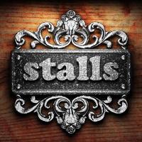 stalls word of iron on wooden background photo