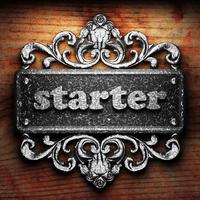 starter word of iron on wooden background photo