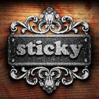 sticky word of iron on wooden background photo