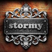 stormy word of iron on wooden background photo