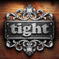 tight word of iron on wooden background photo
