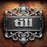 till word of iron on wooden background photo