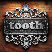 tooth word of iron on wooden background photo