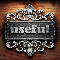 useful word of iron on wooden background photo