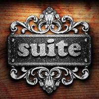 suite word of iron on wooden background photo