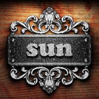 sun word of iron on wooden background photo