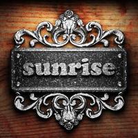 sunrise word of iron on wooden background photo
