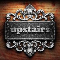upstairs word of iron on wooden background photo