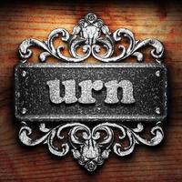 urn word of iron on wooden background photo