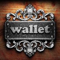 wallet word of iron on wooden background photo