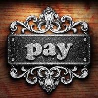 pay word of iron on wooden background photo
