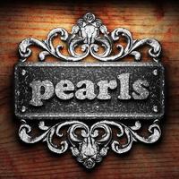 pearls word of iron on wooden background photo