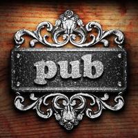 pub word of iron on wooden background photo