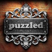 puzzled word of iron on wooden background photo