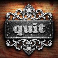 quit word of iron on wooden background photo