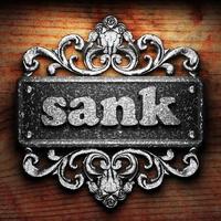 sank word of iron on wooden background photo