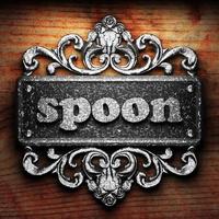 spoon word of iron on wooden background photo