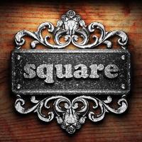 square word of iron on wooden background photo