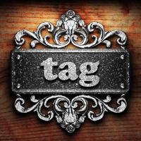 tag word of iron on wooden background photo