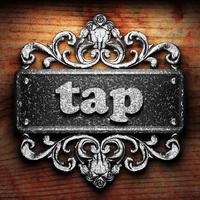 tap word of iron on wooden background photo