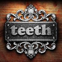 teeth word of iron on wooden background photo