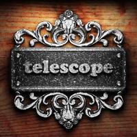 telescope word of iron on wooden background photo