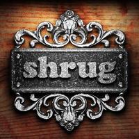 shrug word of iron on wooden background photo