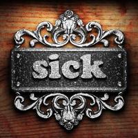 sick word of iron on wooden background photo
