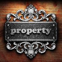 property word of iron on wooden background photo