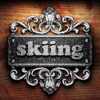skiing word of iron on wooden background photo