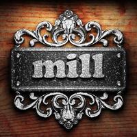 mill word of iron on wooden background photo