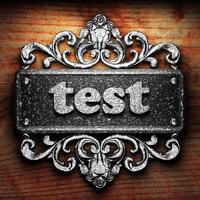 test word of iron on wooden background photo