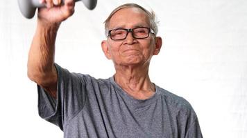 Asian senior man exercising with dumbbells at home. healthy lifestyle video