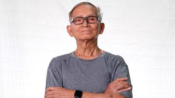 Asian elderly man disapproving expression on face with crossed arms. Serious senior man over a white studio background
