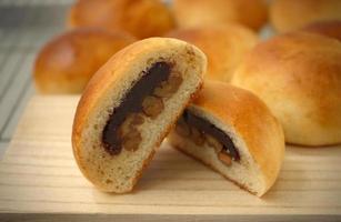 Freshly baked buns lotus red bean cut in half put side by side photo