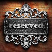 reserved word of iron on wooden background photo