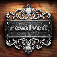 resolved word of iron on wooden background photo