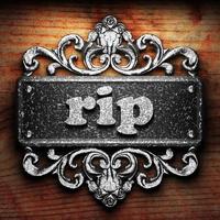 rip word of iron on wooden background photo