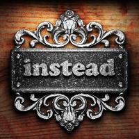 instead word of iron on wooden background photo